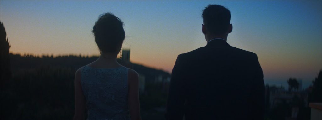 Sweet Matitos fashion film still: the couple seen from behind at dusk
