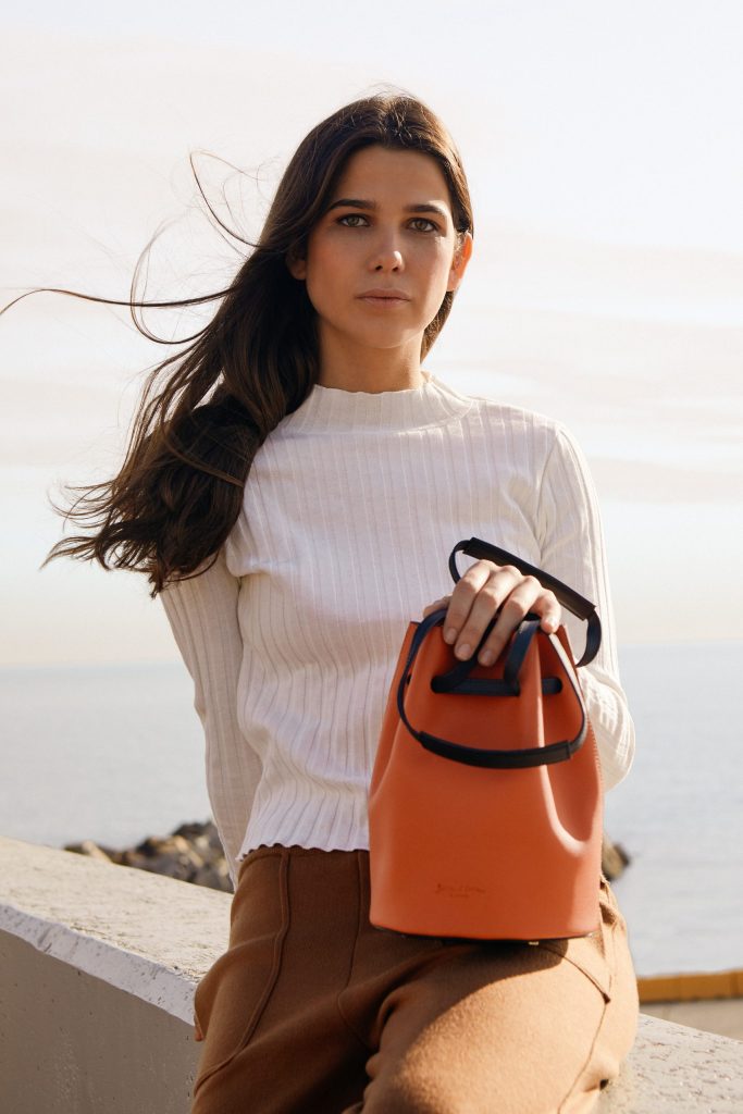 Boria&Coria: model with an orange bag by the sea