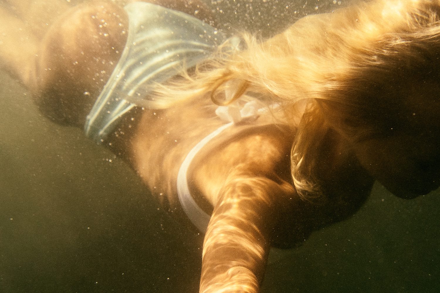 Grain Supply: model under water with light reflections on her skin