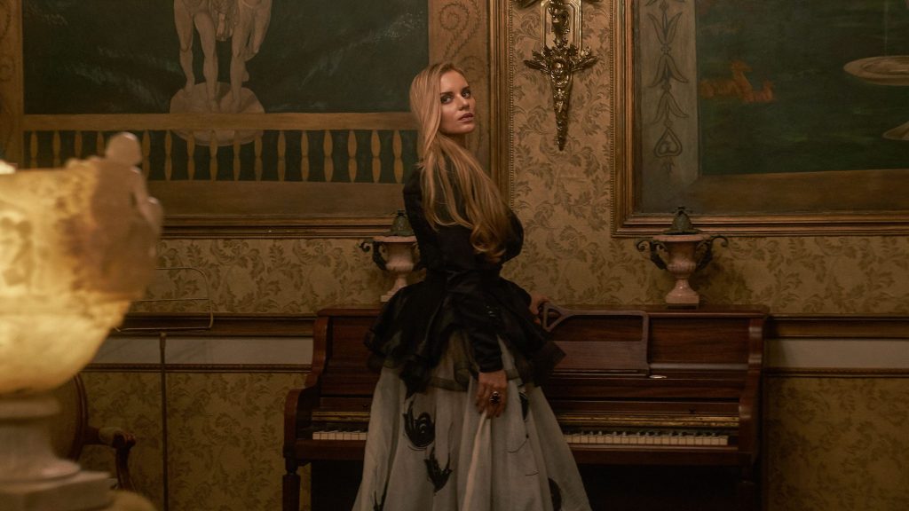 Marcela Ruete standing by a piano