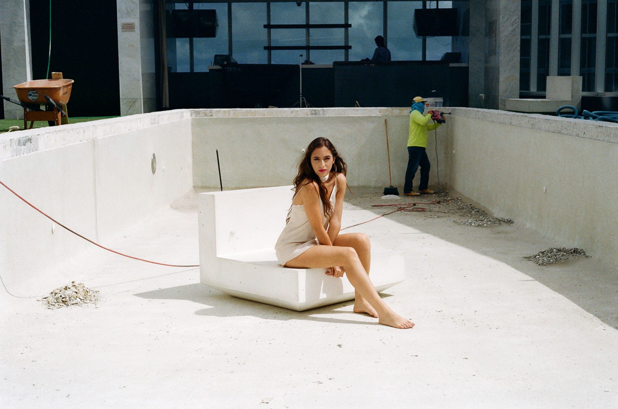 Marcelle sitting in an empty swimming pool